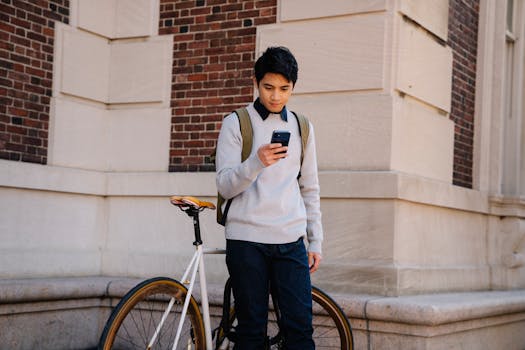 student checking phone in bed