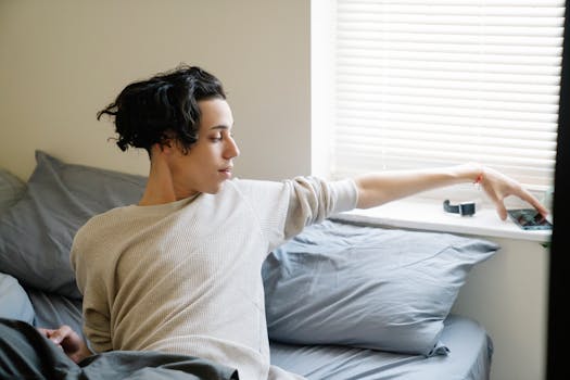 image showing a graduate student checking their phone in bed