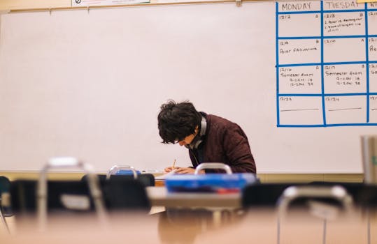 A student studying at a desk with a clear schedule