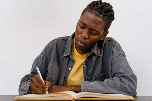 a person reviewing journal entries with a pen and highlighter