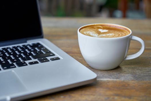 office workspace with a laptop and coffee