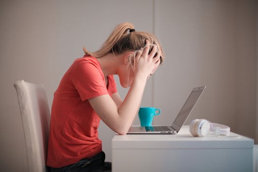 student studying at a cluttered desk